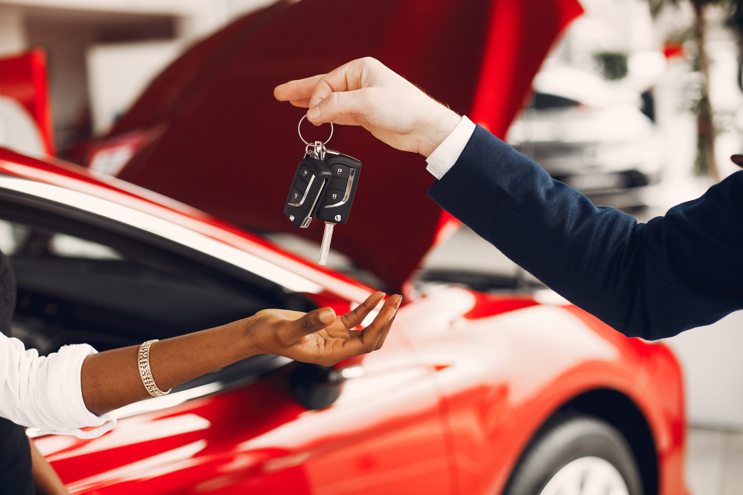 Woman buying the car. Lady in a car salon. Manager with a clients